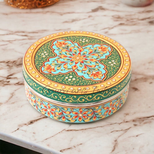 Close-up of hand-painted floral lid on stainless steel spice box
